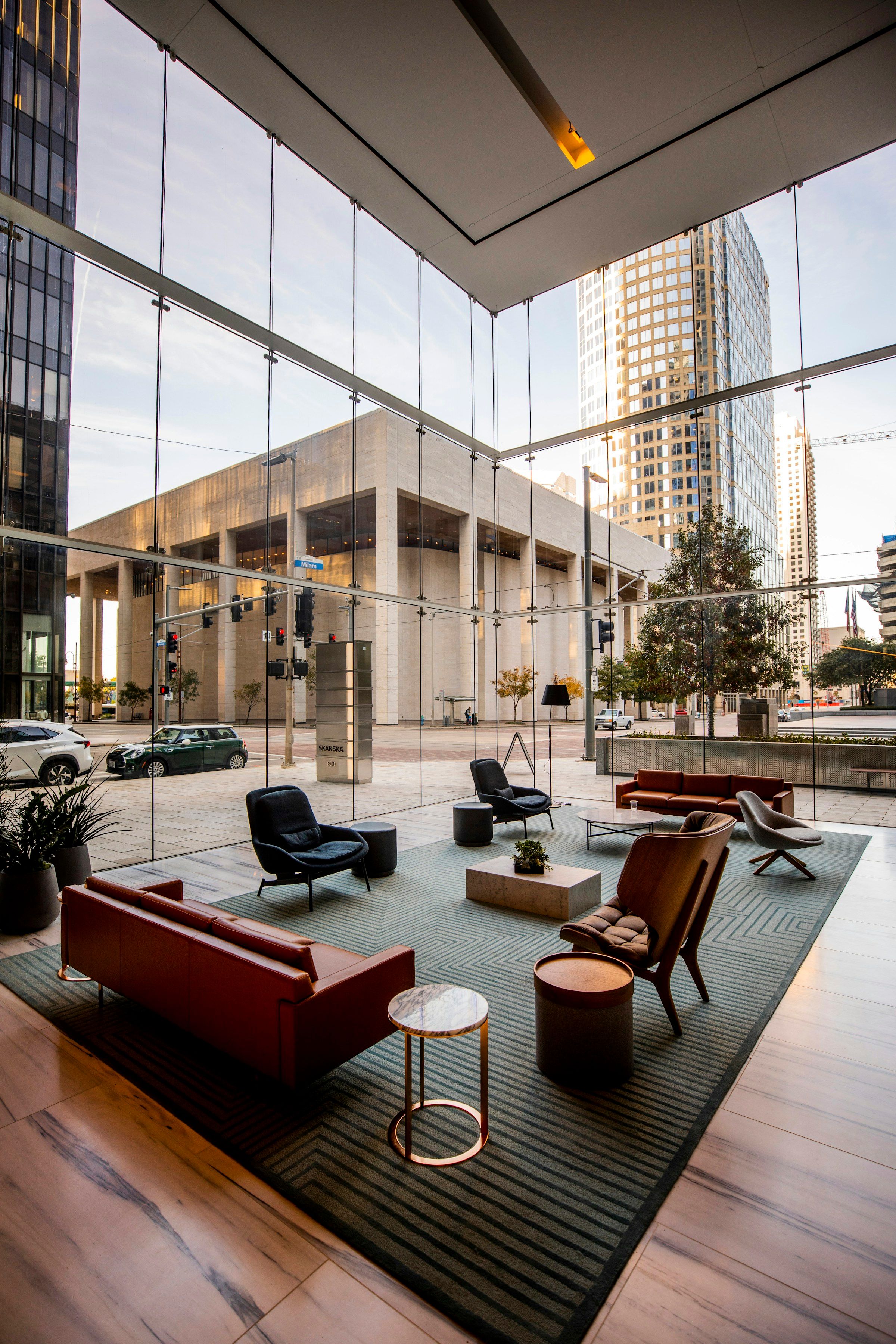A glass-walled office lobby with lounge seating